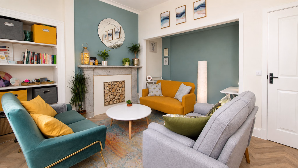 Inviting counselling room featuring yellow sofa and warm fireplace, offering a calm, confidential space for private psychotherapy.